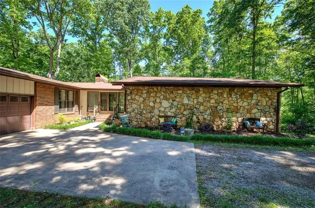 a view of a yard with large trees