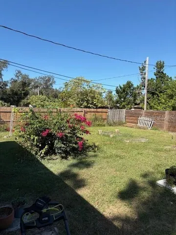 a view of a backyard with chairs