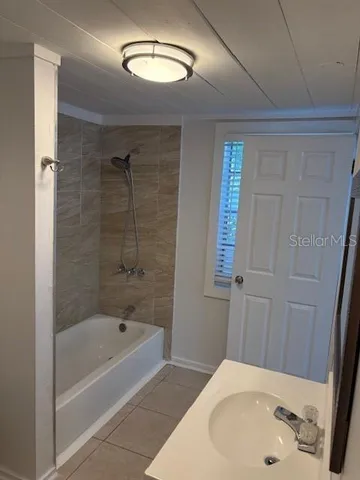 a bathroom with a bathtub and a sink