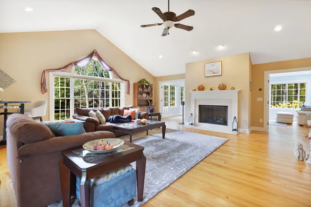 a living room with furniture large window and a fireplace