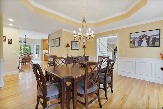 a view of a dining room with furniture wooden floor and chandelier