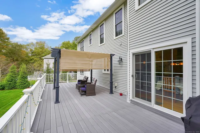 a view of house with deck outdoor seating and mountain view