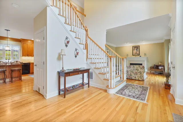 a view of a bedroom with wooden floor and windows