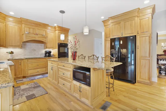 a spacious bathroom with a granite countertop sink and a mirror