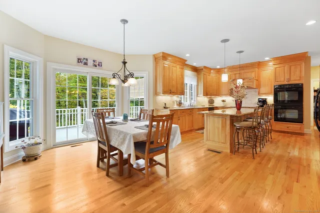 a dining room with furniture window and wooden floor
