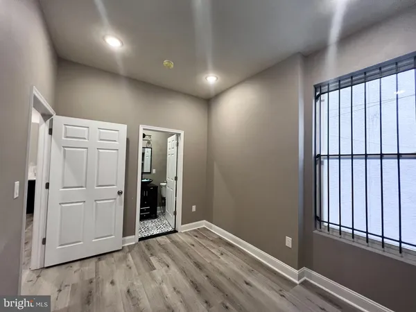 an empty room with wooden floor and closet