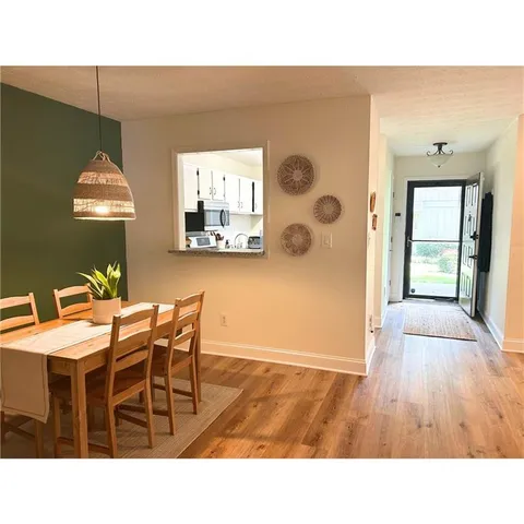 a upper view of a livingroom and a dining room with wooden floor
