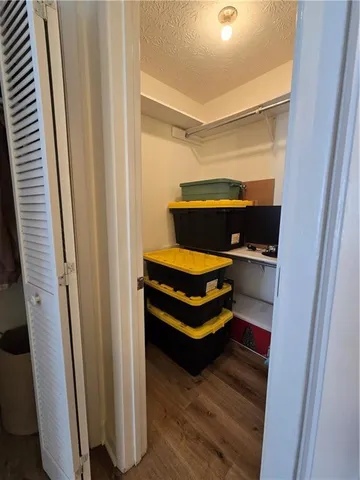 a room with wooden door and furniture