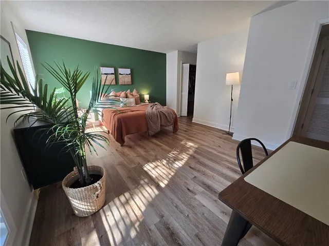 a bedroom with furniture and a potted plant