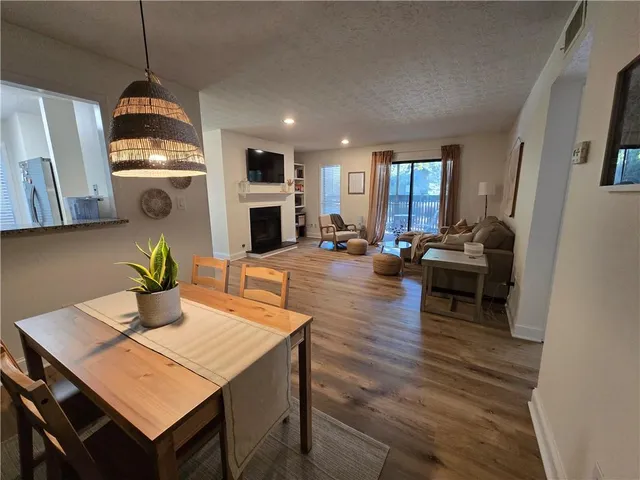 a living room with fireplace furniture and a wooden floor