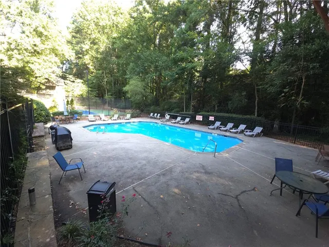 a view of a backyard with swimming pool