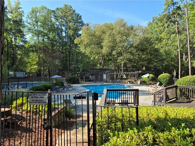 a view of swimming pool with a garden and trees