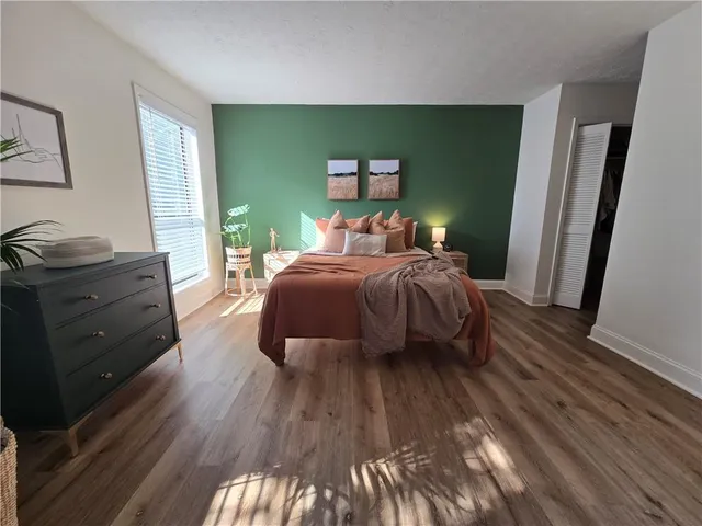 a bedroom with a bed and a dresser