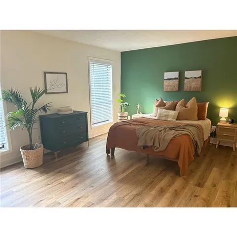 a living room with furniture and potted plant
