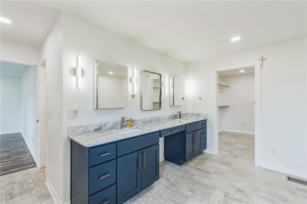 500 Coleman Mill Road Carrollton, GA 30116 - Photo 21 of 83 a spacious bathroom with a granite countertop double vanity and mirror