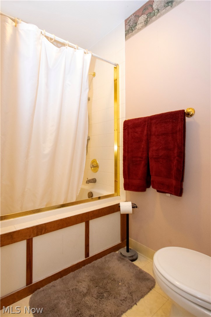 1043 North Honeytown Road Wooster, OH 44691 - Photo 22 of 46 Tub/shower combination featuring brass fixtures and a gold-framed enclosure