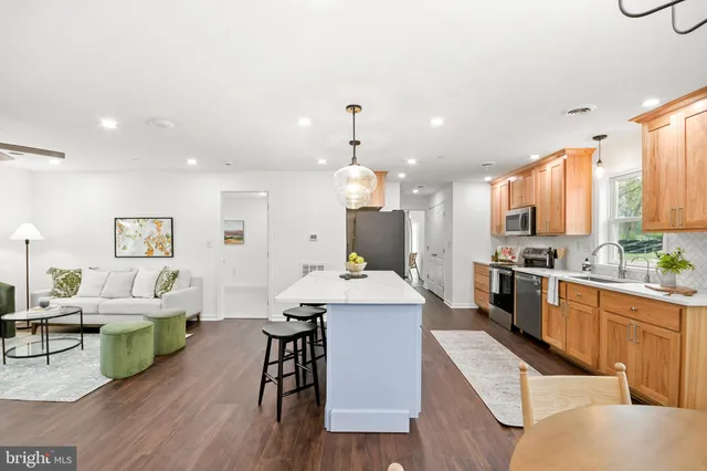 a large kitchen with a table and chairs
