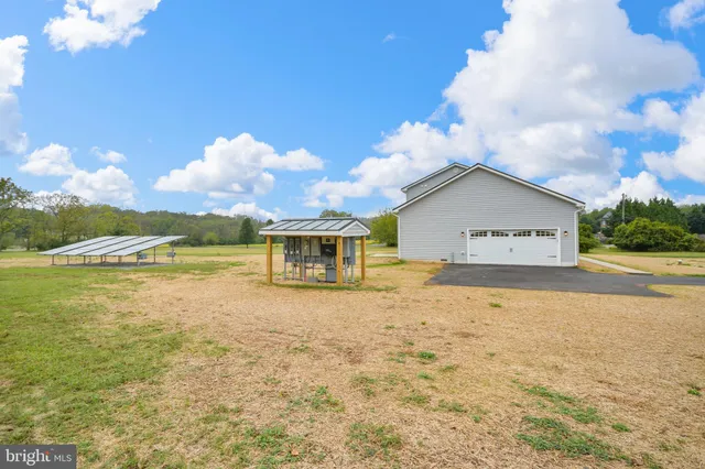 a view of a house with a yard and lake view