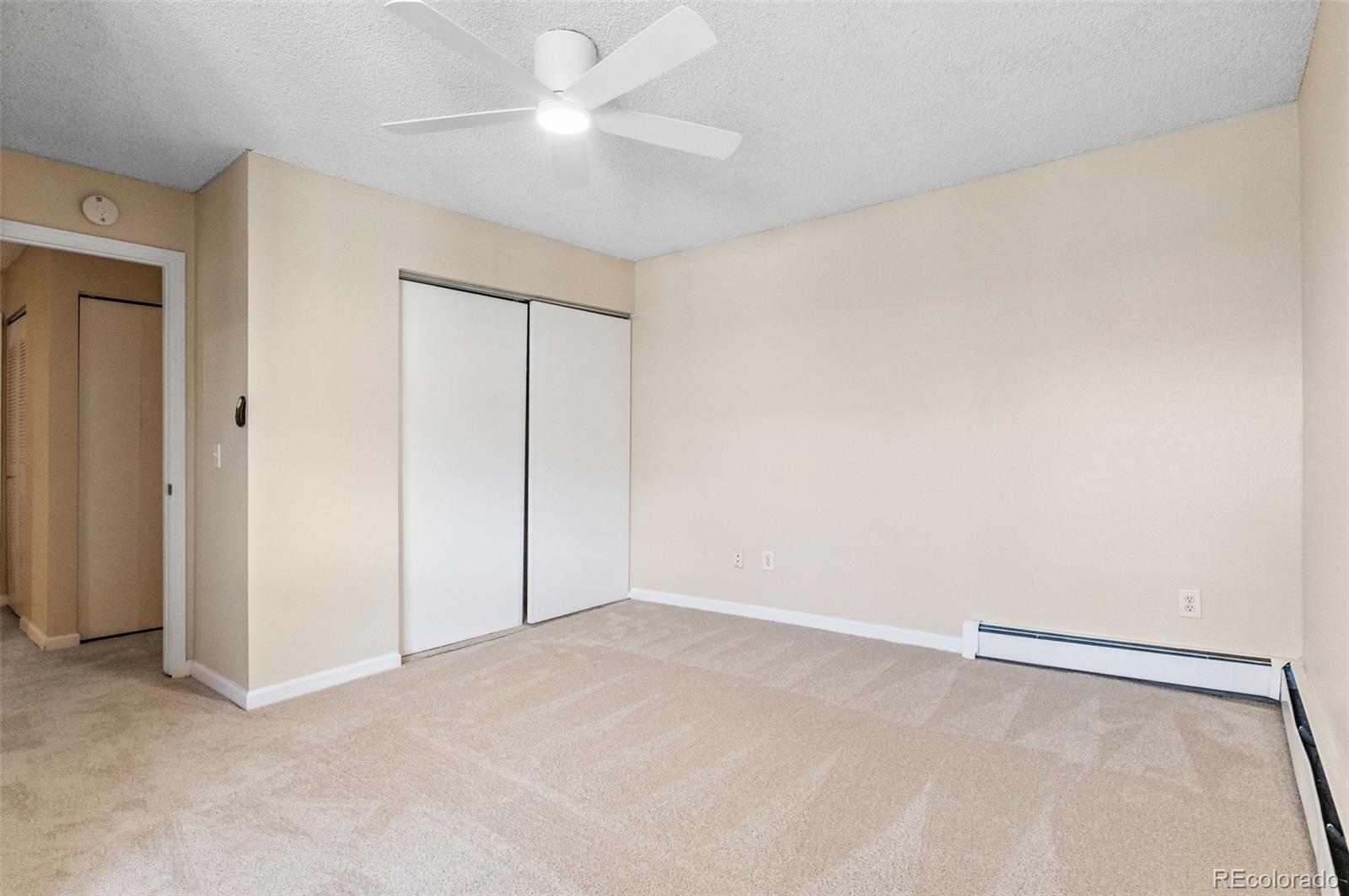 3035 Oneal Parkway, Unit 37V Boulder, CO 80301 - Photo 22 of 49 an empty room with a ceiling fan and a window