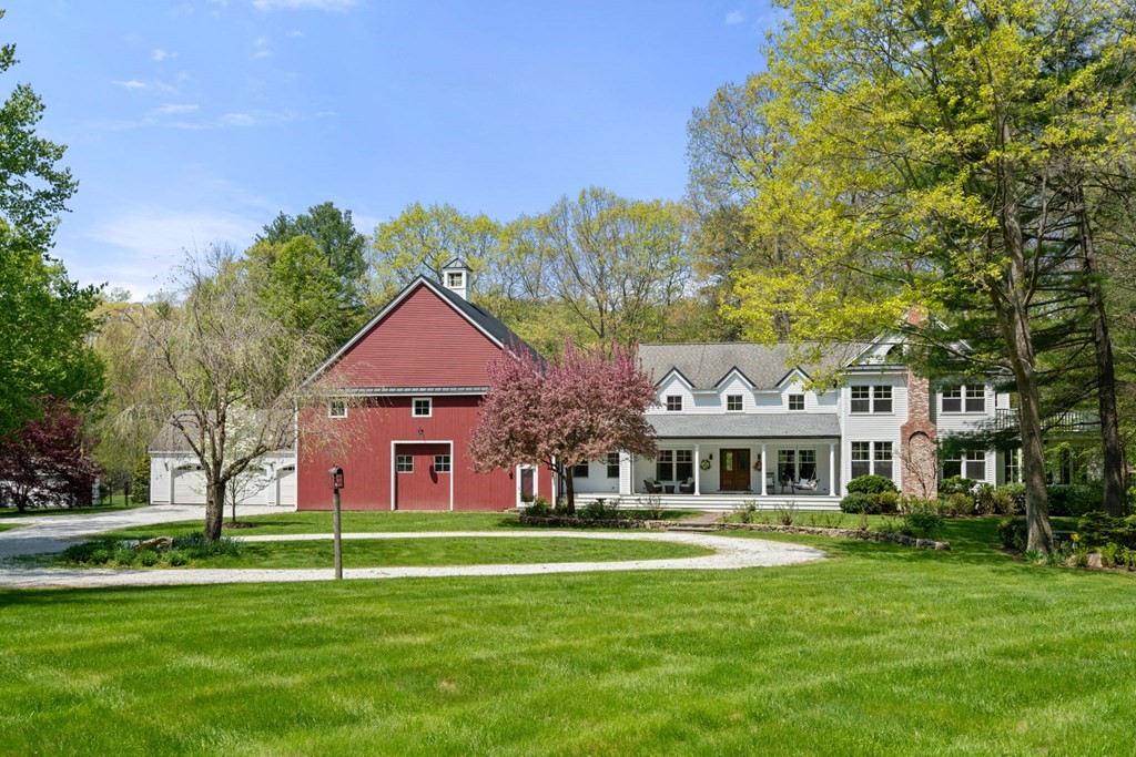 a front view of house with yard and green space