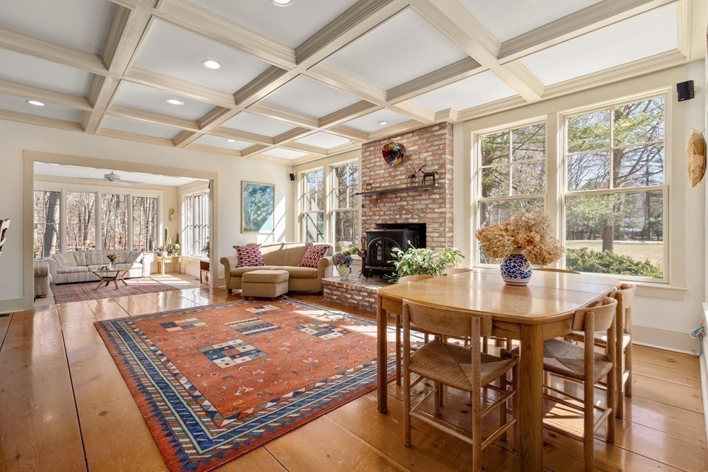 9 Lantern Lane Natick, MA 01760 - Photo 12 of 42 a living room with furniture a fireplace and a table