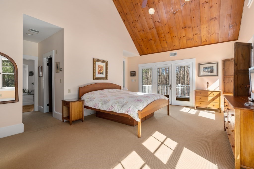 9 Lantern Lane Natick, MA 01760 - Photo 21 of 42 a bedroom with a bed and wooden floor