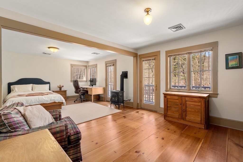 9 Lantern Lane Natick, MA 01760 - Photo 24 of 42 a bedroom with a bed and glass window