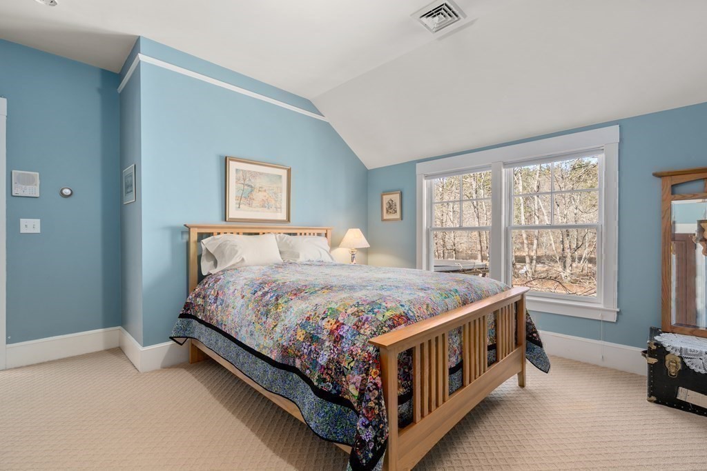 9 Lantern Lane Natick, MA 01760 - Photo 26 of 42 a bed sitting in a bedroom next to a window