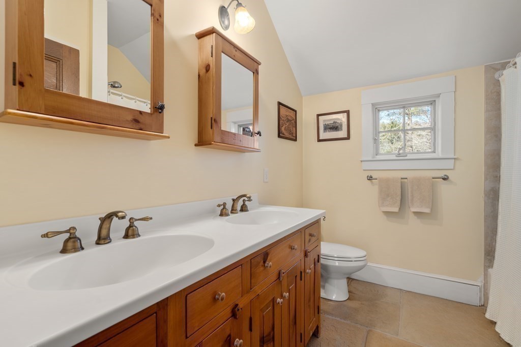 9 Lantern Lane Natick, MA 01760 - Photo 27 of 42 a bathroom with a sink and a mirror