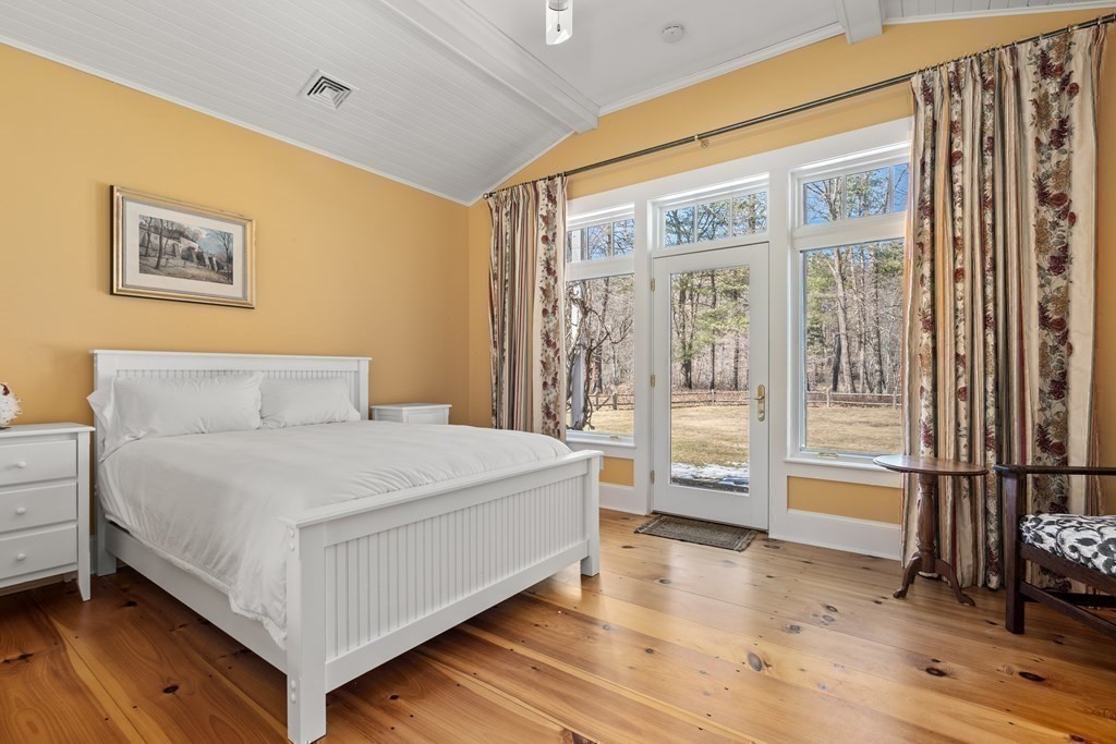 9 Lantern Lane Natick, MA 01760 - Photo 30 of 42 a bedroom with a large bed and a large window