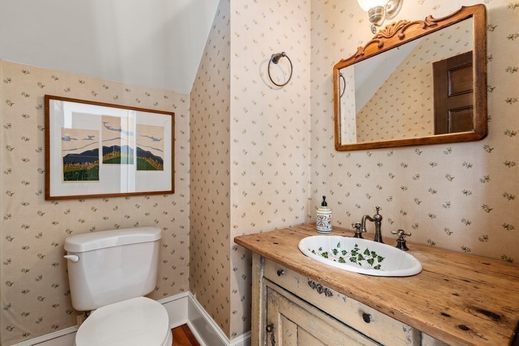 9 Lantern Lane Natick, MA 01760 - Photo 33 of 42 a bathroom with a granite countertop sink and a mirror