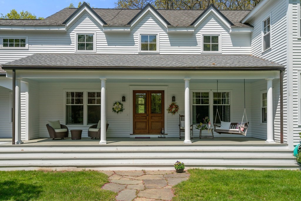 9 Lantern Lane Natick, MA 01760 - Photo 39 of 42 a view of a house with a large windows and a table and chairs