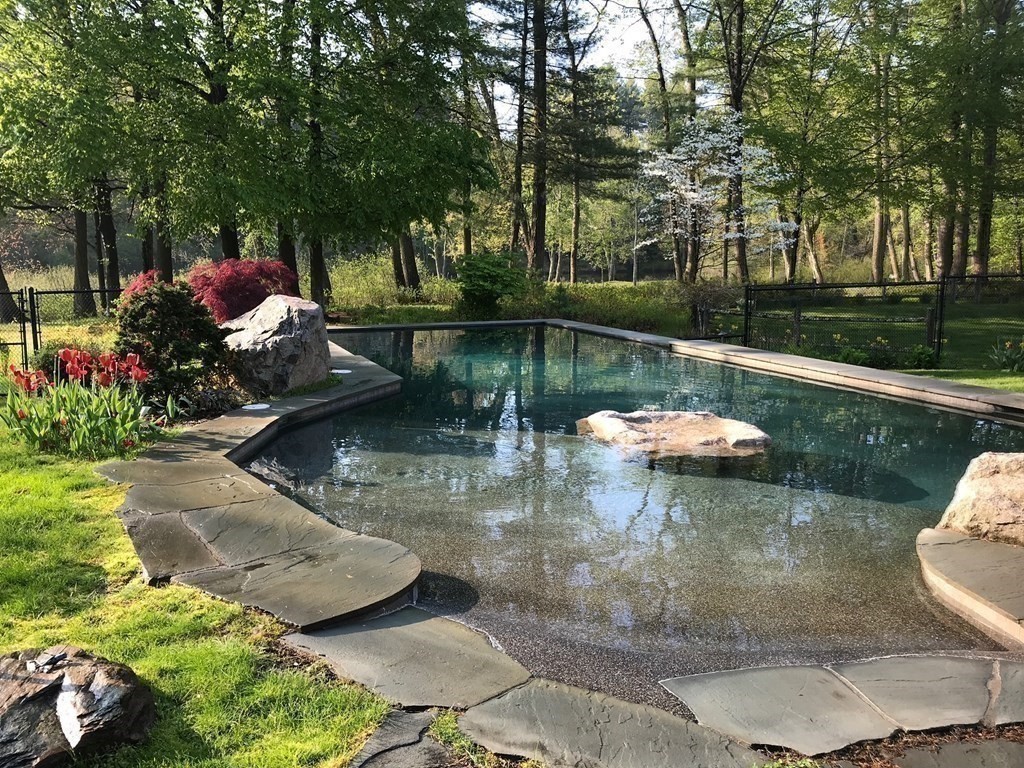 9 Lantern Lane Natick, MA 01760 - Photo 4 of 42 a view of a lake with a house in the background