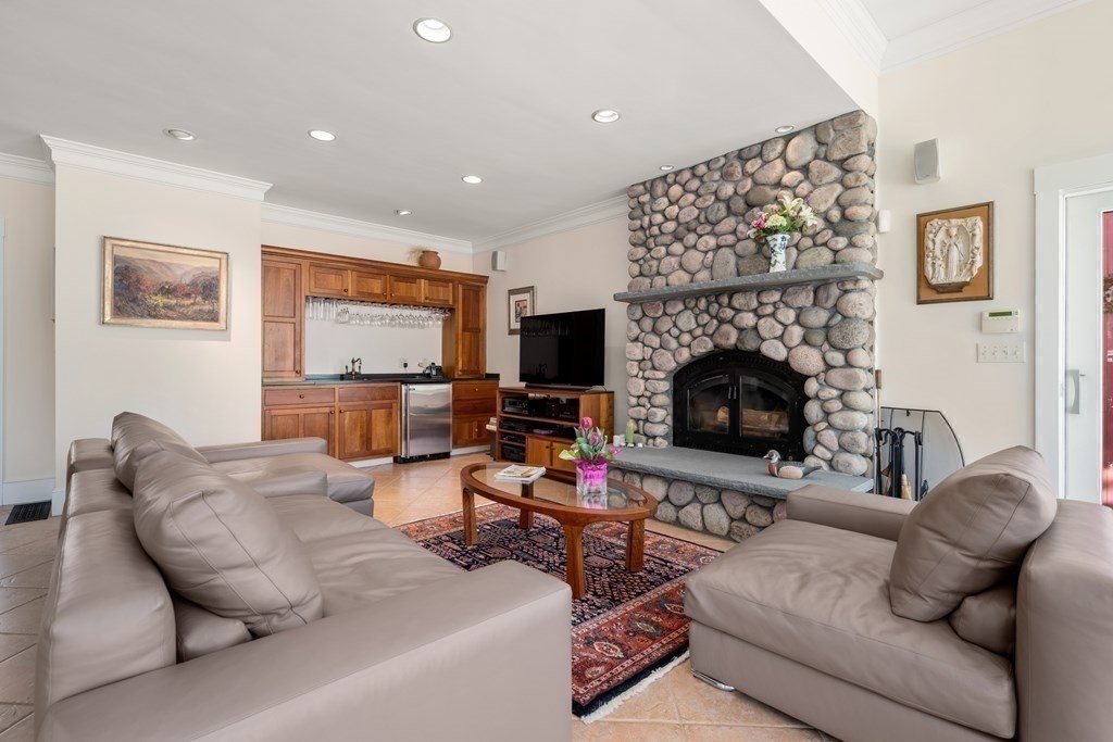 9 Lantern Lane Natick, MA 01760 - Photo 8 of 42 a living room with furniture or fireplace and a flat screen tv