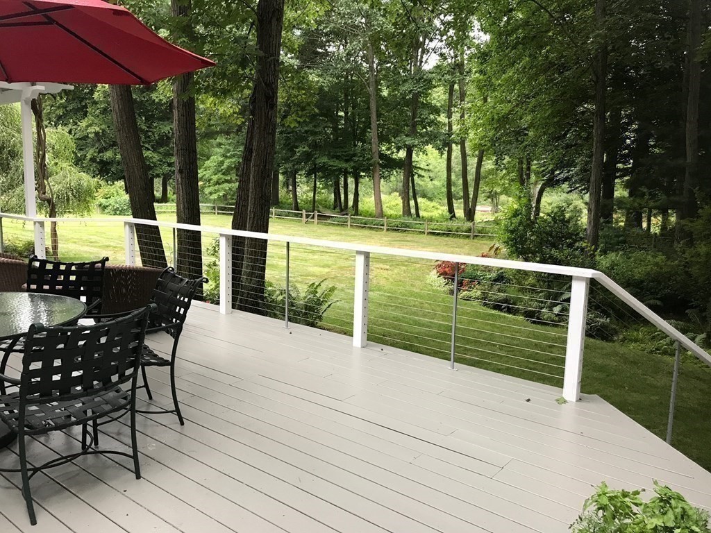 9 Lantern Lane Natick, MA 01760 - Photo 10 of 42 a view of a deck with chairs and large trees