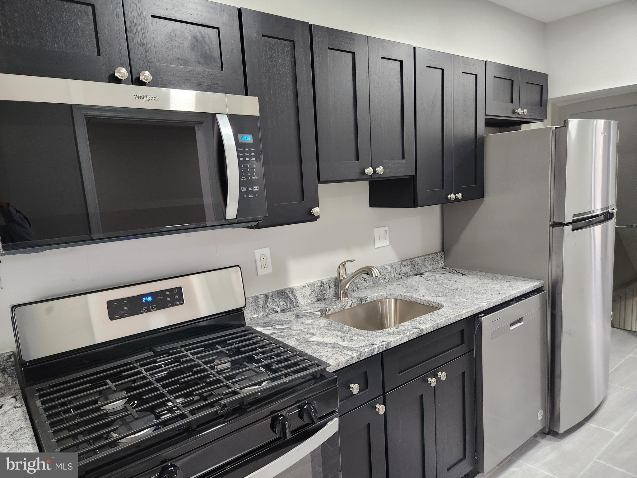 4113 Century Road Baltimore, MD 21206 - Photo 8 of 27 a kitchen with a sink and a refrigerator