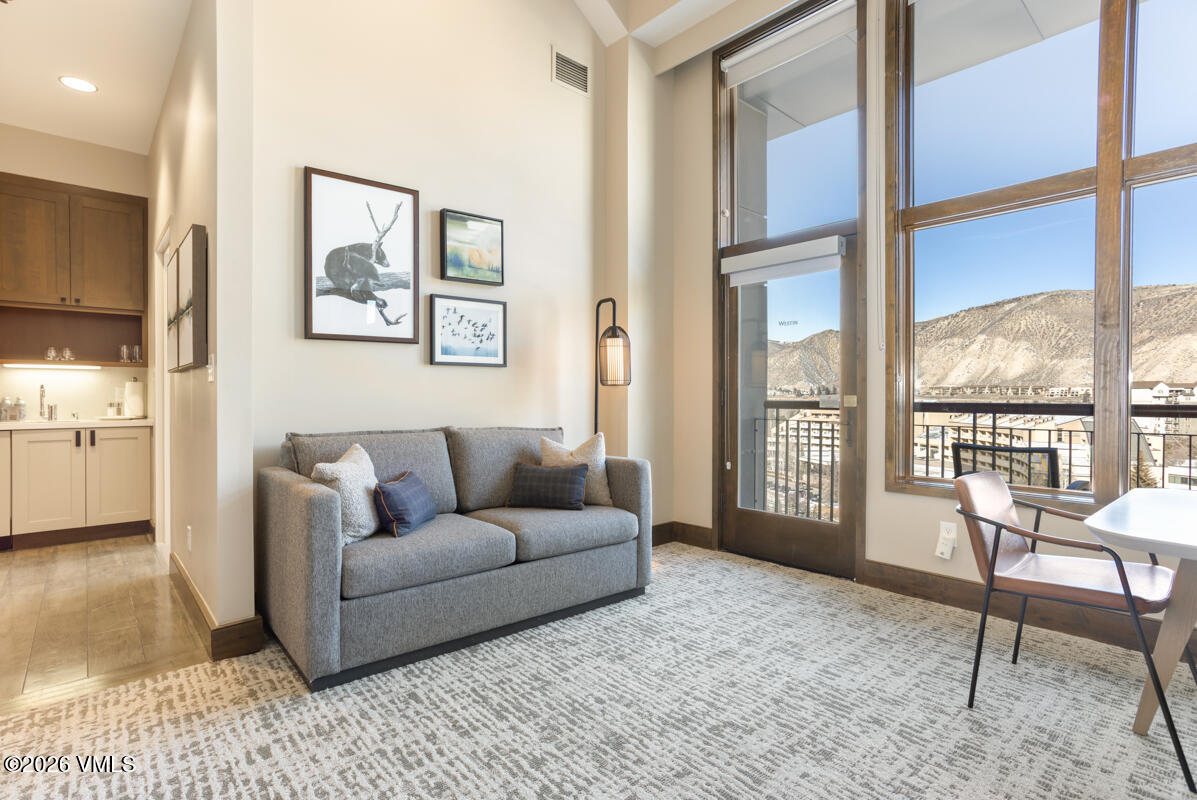 126 Riverfront Lane, Unit 912 Avon, CO 81620 - Photo 13 of 28 a living room with furniture and a large window