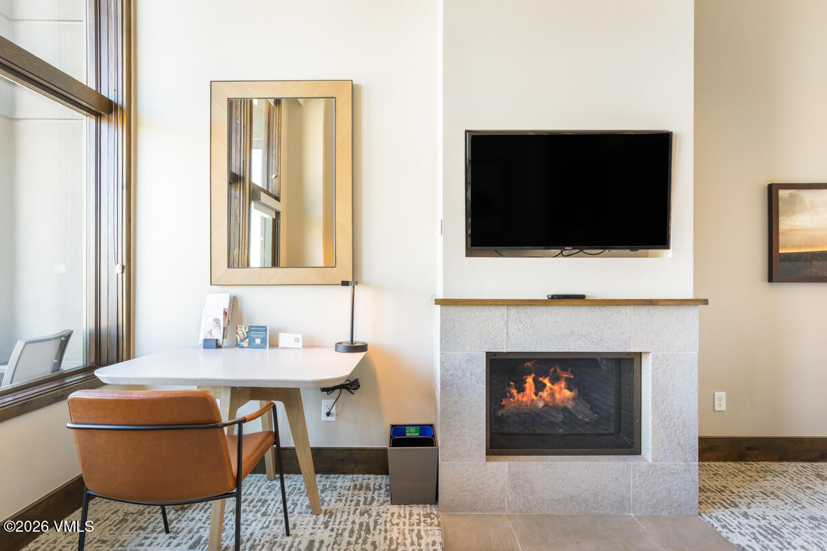 126 Riverfront Lane, Unit 912 Avon, CO 81620 - Photo 16 of 28 a living room with a fireplace and a flat screen tv