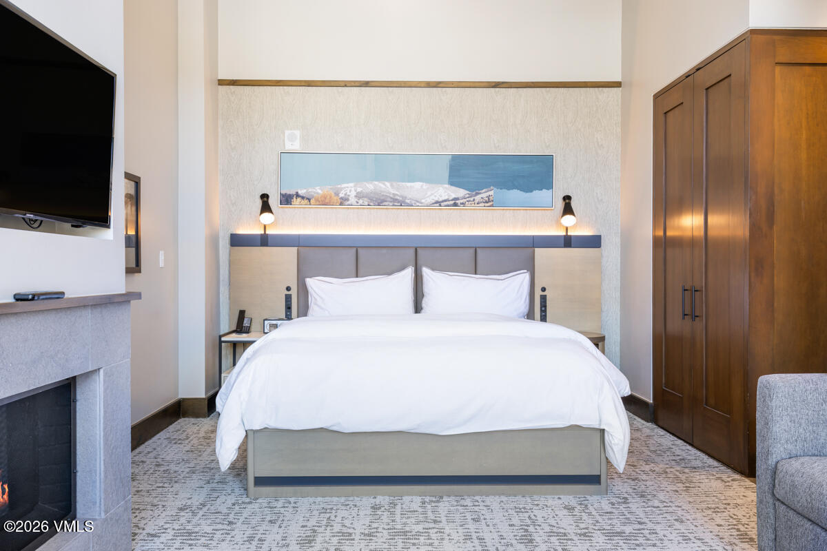 126 Riverfront Lane, Unit 912 Avon, CO 81620 - Photo 21 of 28 a bedroom with a bed and a flat screen tv