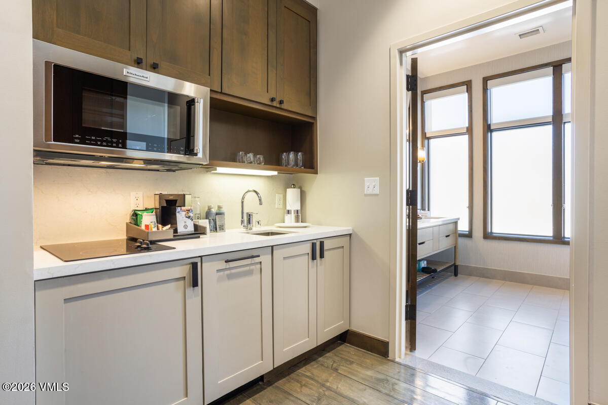 126 Riverfront Lane, Unit 912 Avon, CO 81620 - Photo 24 of 28 a kitchen with stainless steel appliances granite countertop a sink and a microwave