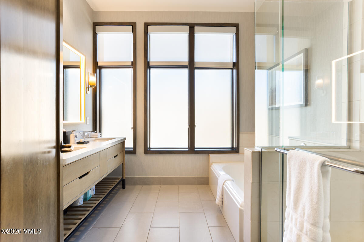 126 Riverfront Lane, Unit 912 Avon, CO 81620 - Photo 25 of 28 a bathroom with a double vanity sink and a bathtub