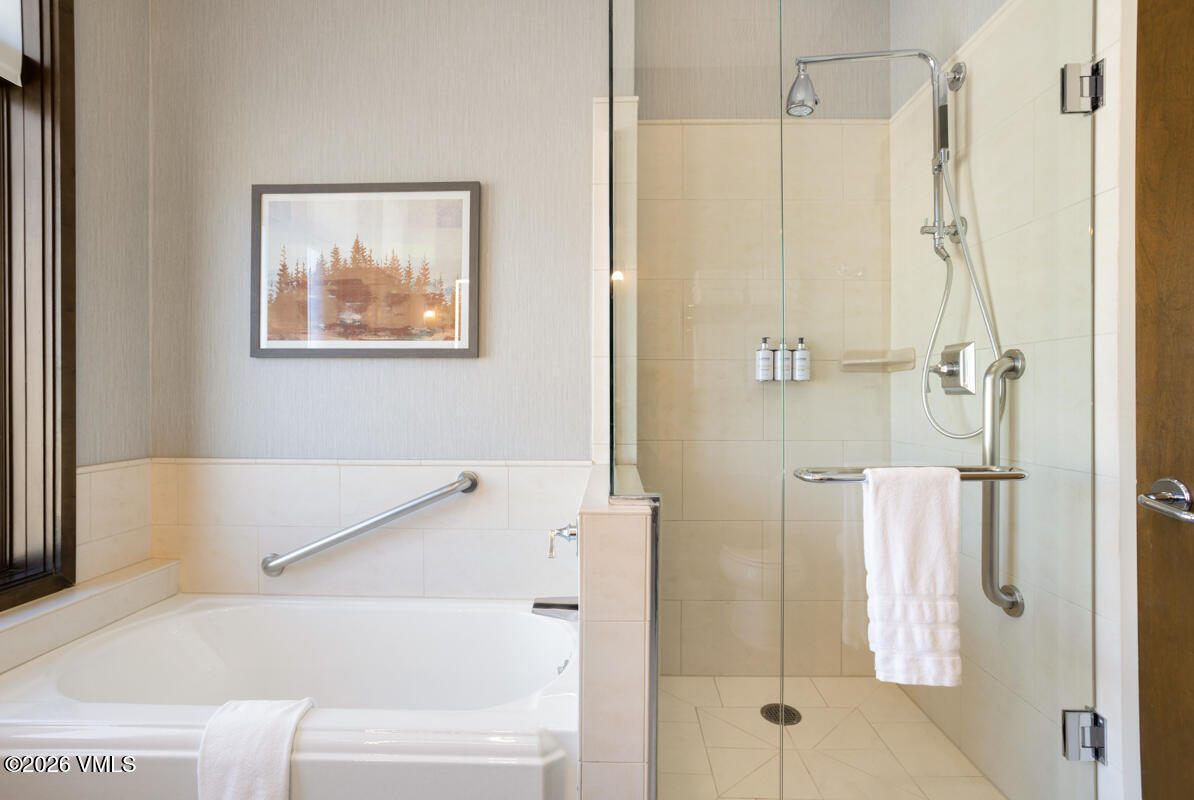 126 Riverfront Lane, Unit 912 Avon, CO 81620 - Photo 27 of 28 a bathroom with a bathtub and a shower