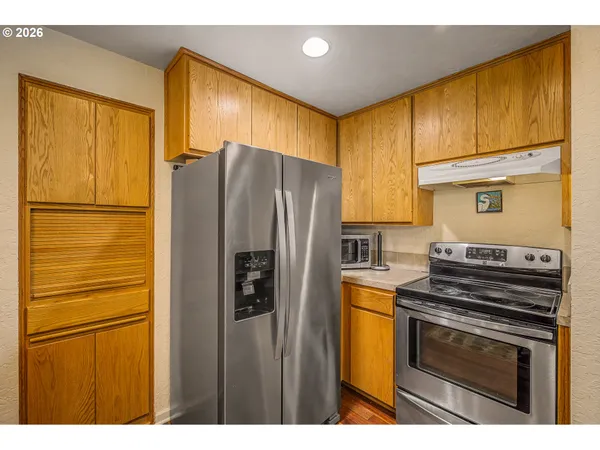 a kitchen with a refrigerator stove and microwave
