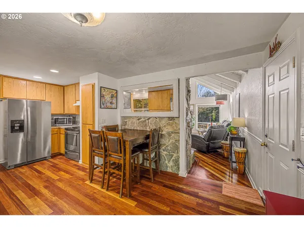 a living room with furniture a wooden floor and next to a window