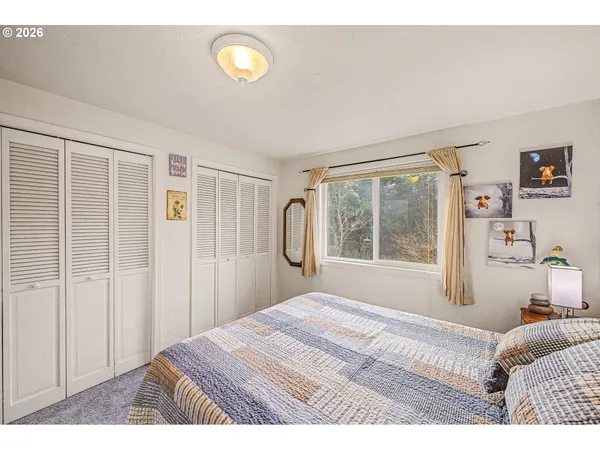 a bedroom with a large bed and a window