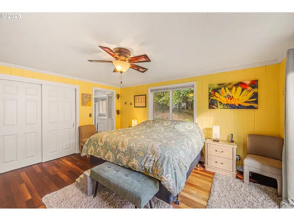 a spacious bedroom with a bed and a chandelier