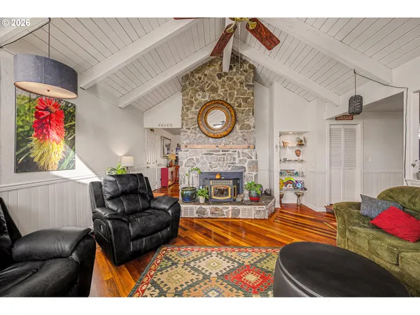 a living room with furniture a clock and a fireplace