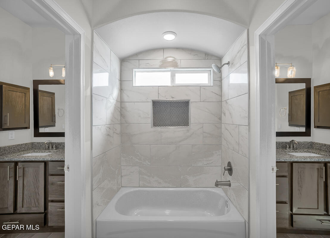 6935 Levee Circle El Paso, TX 79932 - Photo 30 of 32 a bathroom with a tub sink and mirror
