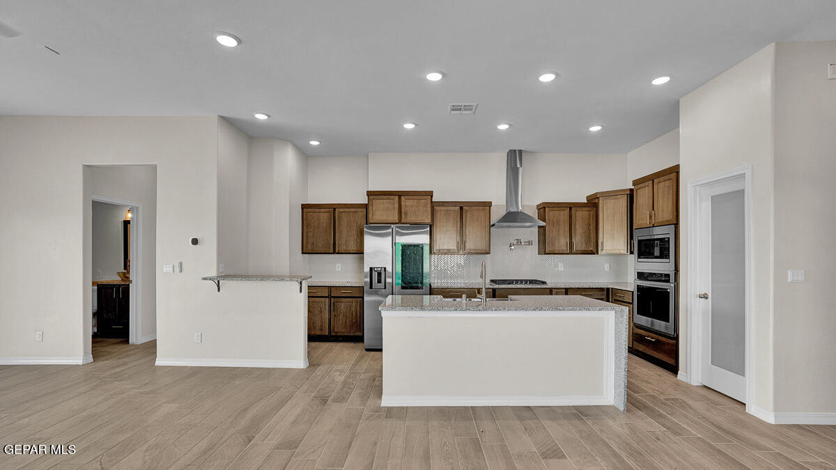 6935 Levee Circle El Paso, TX 79932 - Photo 8 of 32 a kitchen with stainless steel appliances a stove top oven a sink and a refrigerator