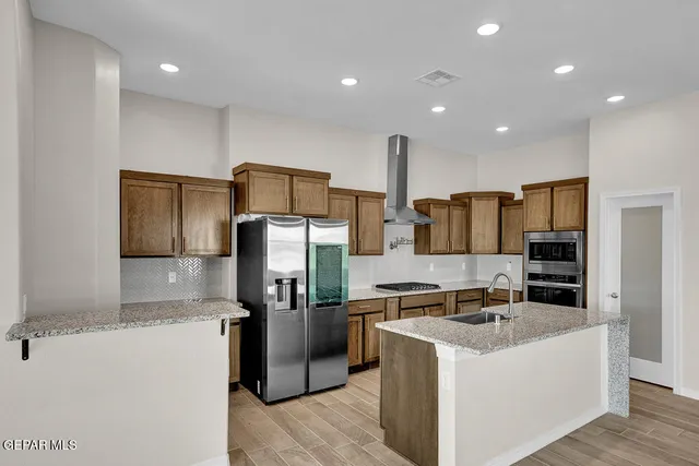 a kitchen with center island table and a sink
